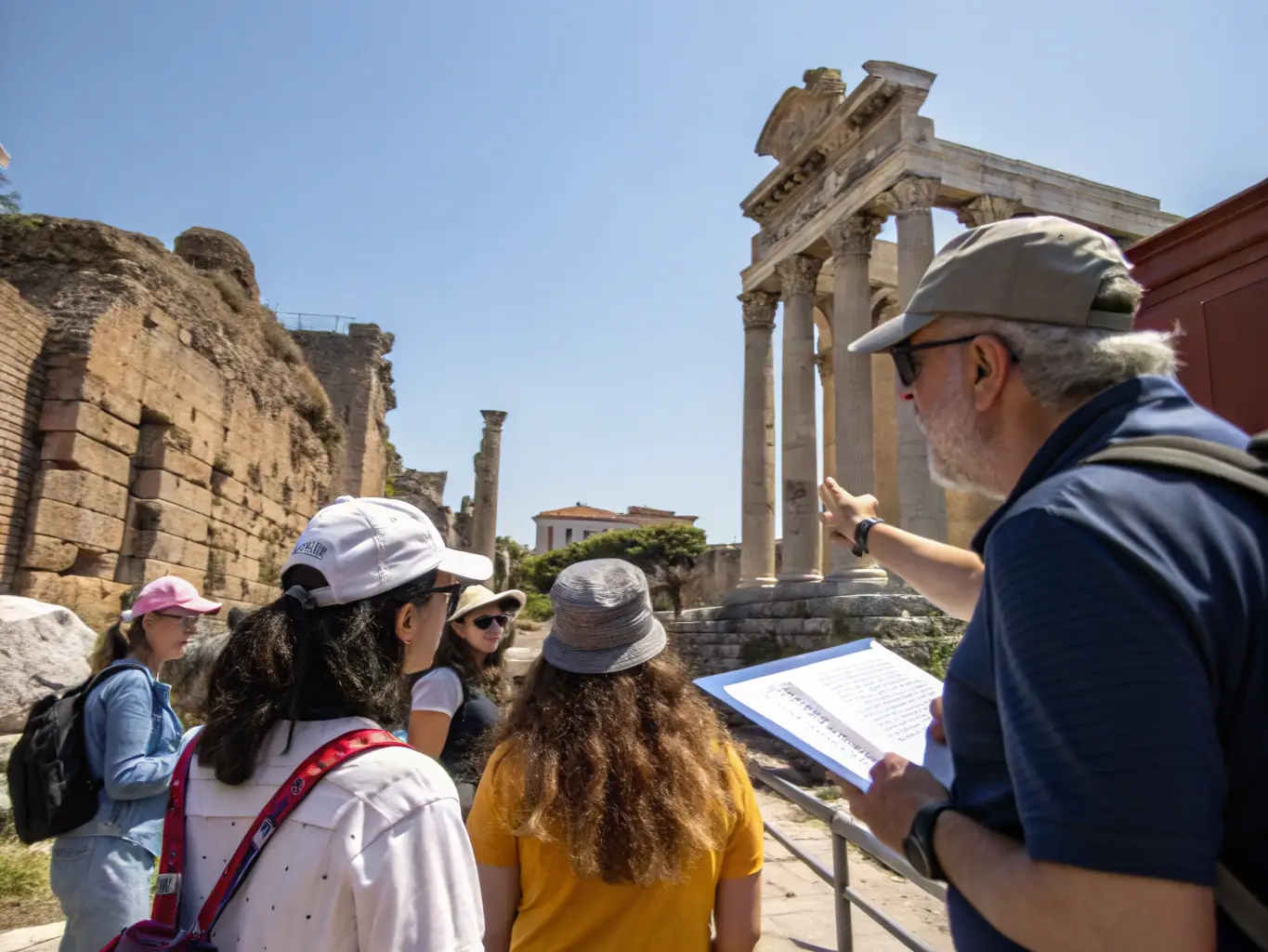A photograph capturing a guided tour of a historical site in Lugarde, led by a knowledgeable LUGARDESPACE guide, with participants listening attentively and exploring the architectural details.