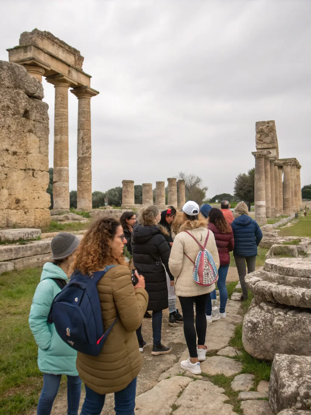 A photo of a guided tour group exploring a historical landmark in Lugarde, with a knowledgeable guide explaining the significance of the site.